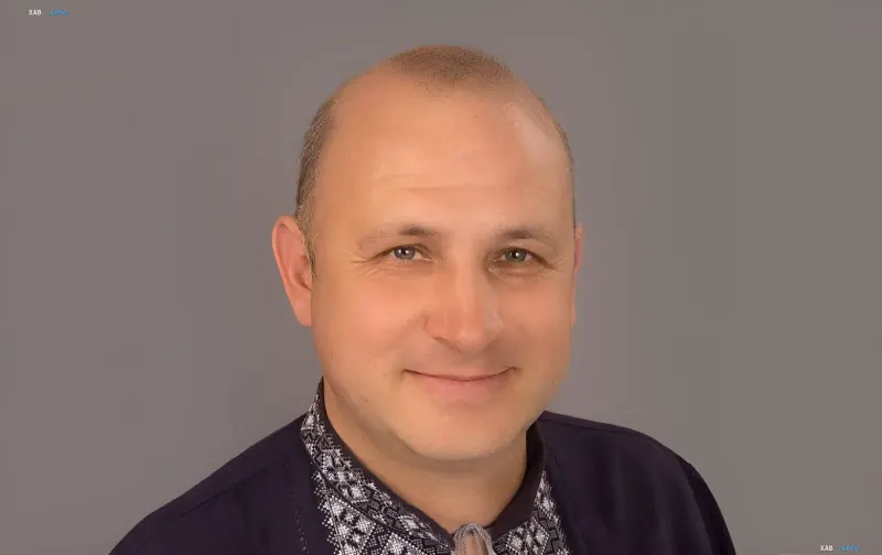 Portrait of Lviv Regional Council Deputy Svyatoslav Sheremeta against a gray background