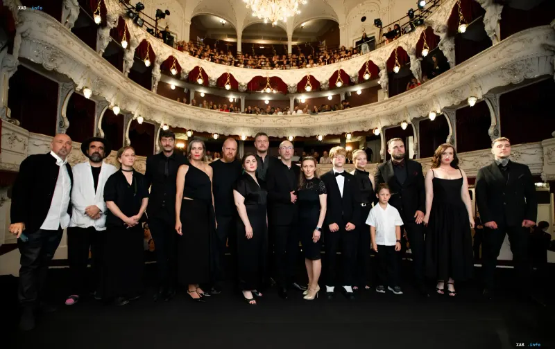 Director and crew members of TO DIE TO LIVE on stage in a historic theater before the audience