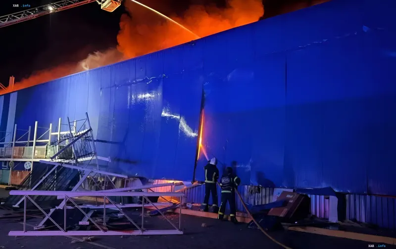 Fire and rescue workers at the site of a night drone strike on a shopping center in Uman