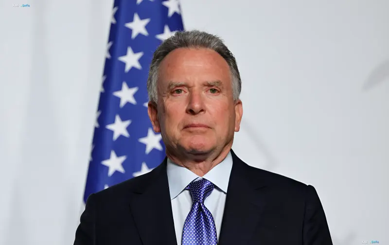 Steve Witkoff in front of a US flag during a diplomatic trip to Russia