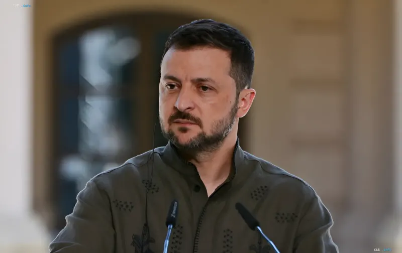 President of Ukraine Volodymyr Zelenskyy speaking at a press conference wearing a khaki embroidered shirt