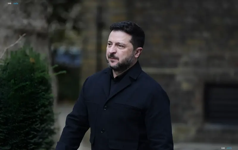 Ukrainian President Volodymyr Zelenskyy wearing a dark coat outdoors during an official visit