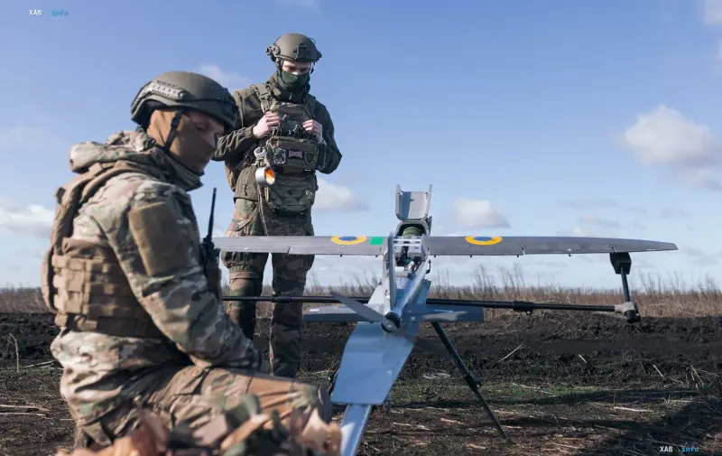 Ukrainian military operators prepare a reconnaissance or strike drone for launch in the field