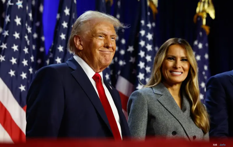 US President Donald Trump and First Lady Melania Trump smiling in front of American flags during an event