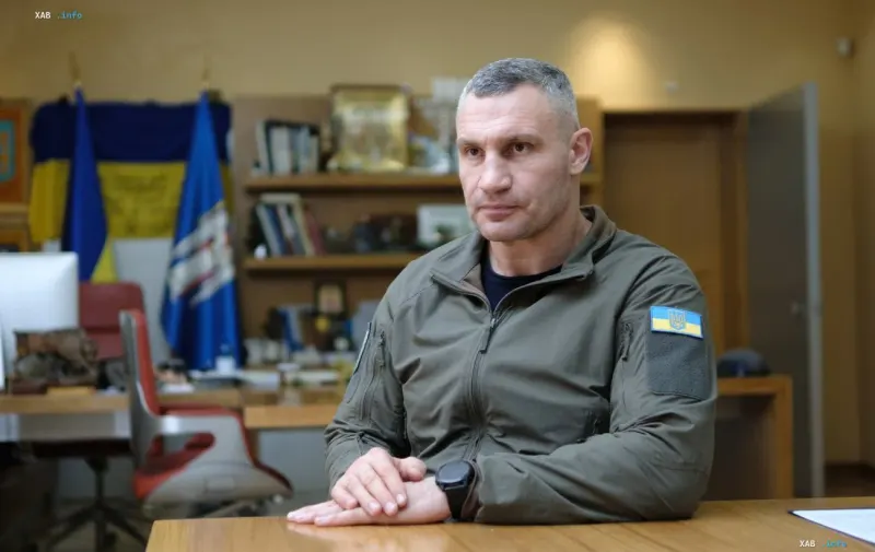 Kyiv Mayor Vitali Klitschko in military camouflage against the background of the Ukrainian flag in his office