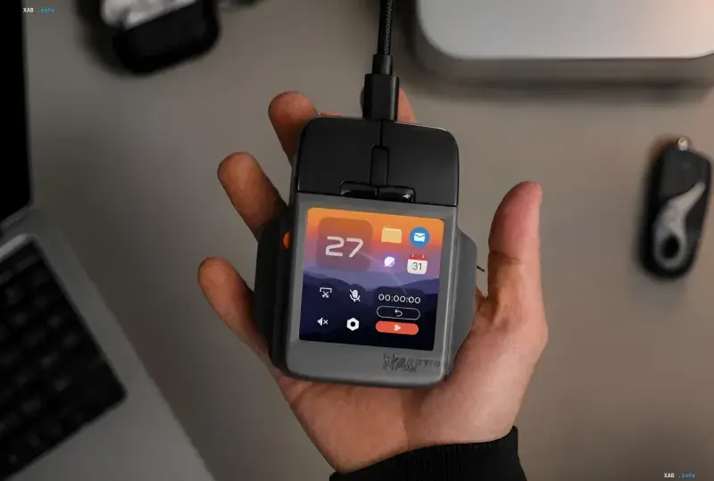 A person holding the Arctic Fox Super Mouse wired computer mouse with a touchscreen