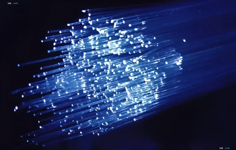 A bundle of glowing blue optical fibers demonstrating high-speed petabit-per-second data transmission technologies
