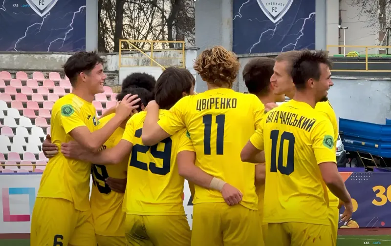Kharkiv Metalist football players in yellow kits celebrating a scored goal on the pitch