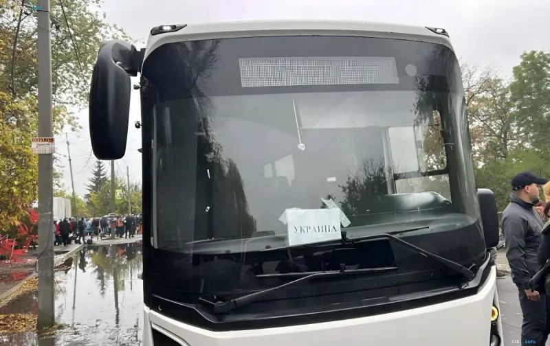 White bus with an Ukraine sign on the windshield during human evacuation