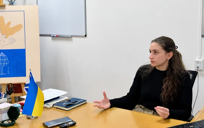 Заступниця посла Ізраїлю в Україні Міла Цур дає інтерв'ю за столом з українським прапором