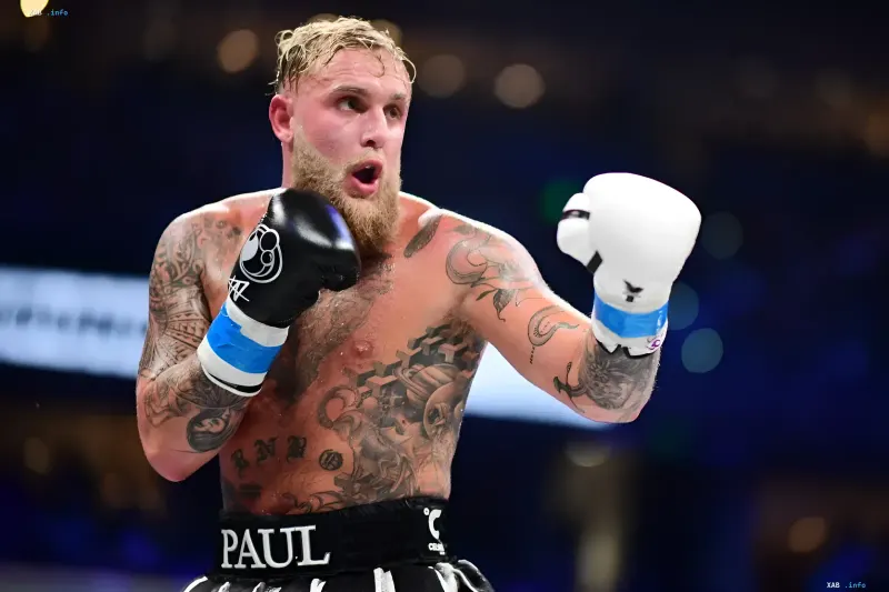 American boxer and content creator Jake Paul with tattoos in the ring wearing boxing gloves
