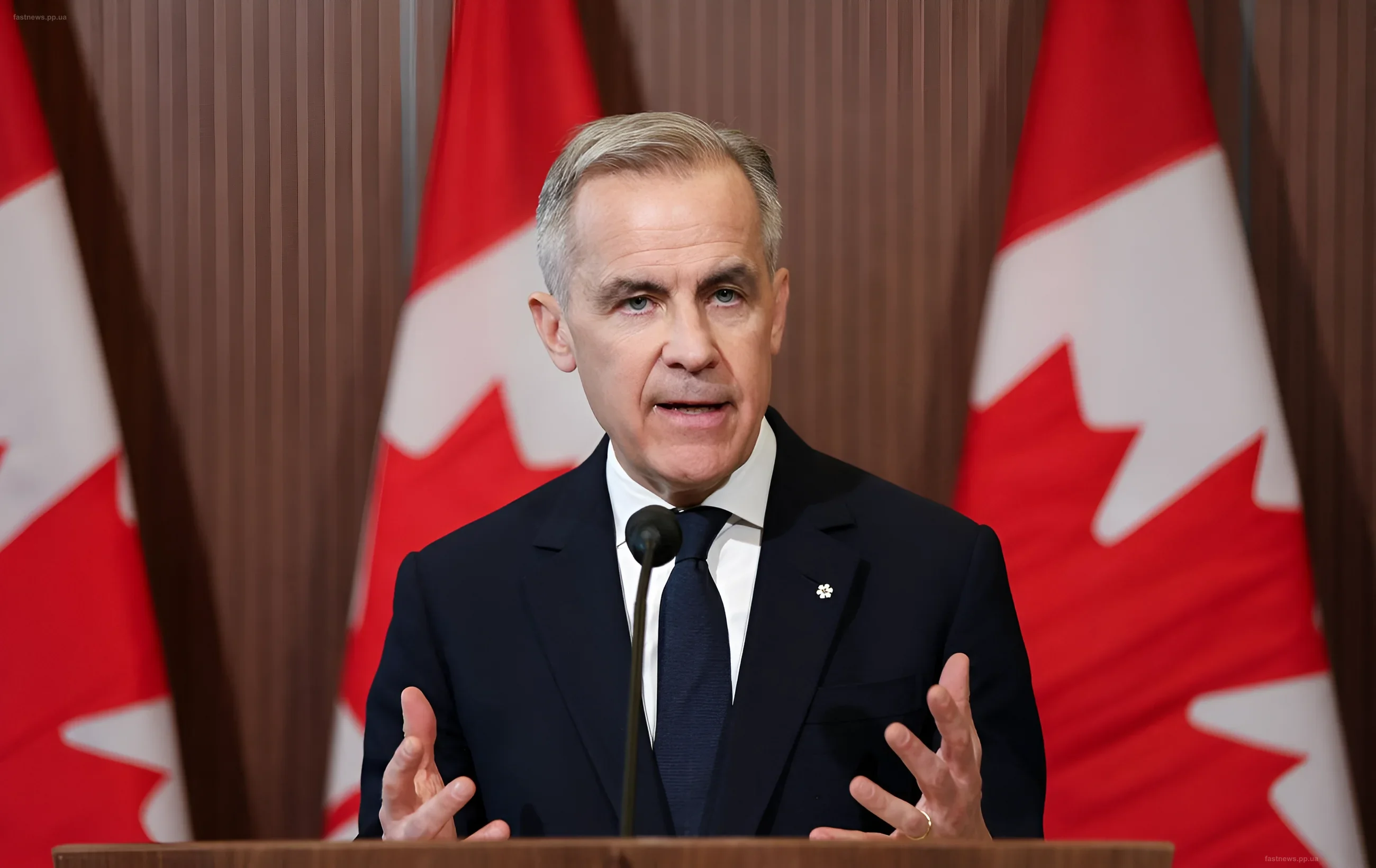 Canadian Prime Minister Mark Carney speaking at a podium in front of Canadian flags, announcing the purchase of Swedish aircraft