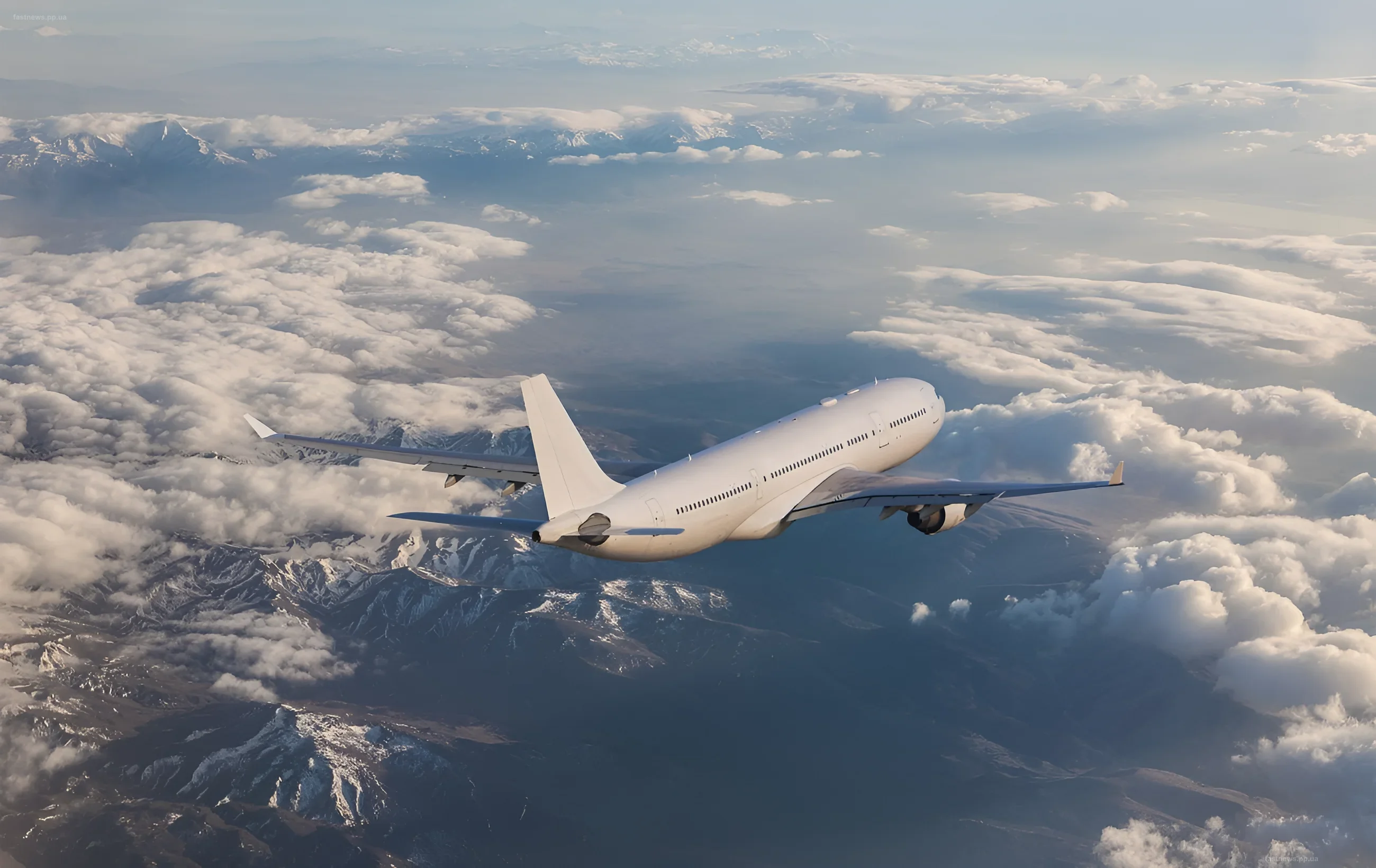 Civilian airplane flying above clouds and snow-capped mountains, illustrating the theme of aviation and flight