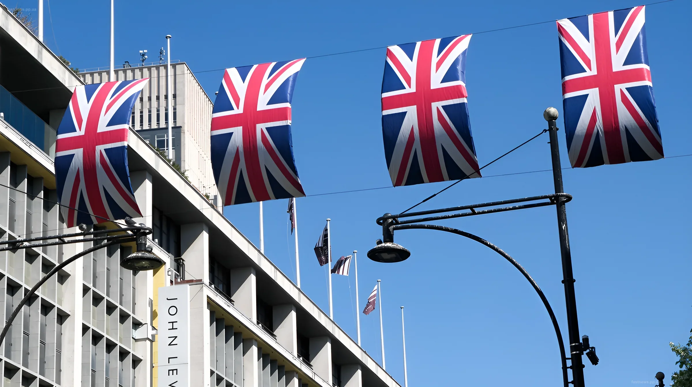 British flags against the backdrop of an intelligence agency building, illustrating the theme of the threat from Russia to UK infrastructure