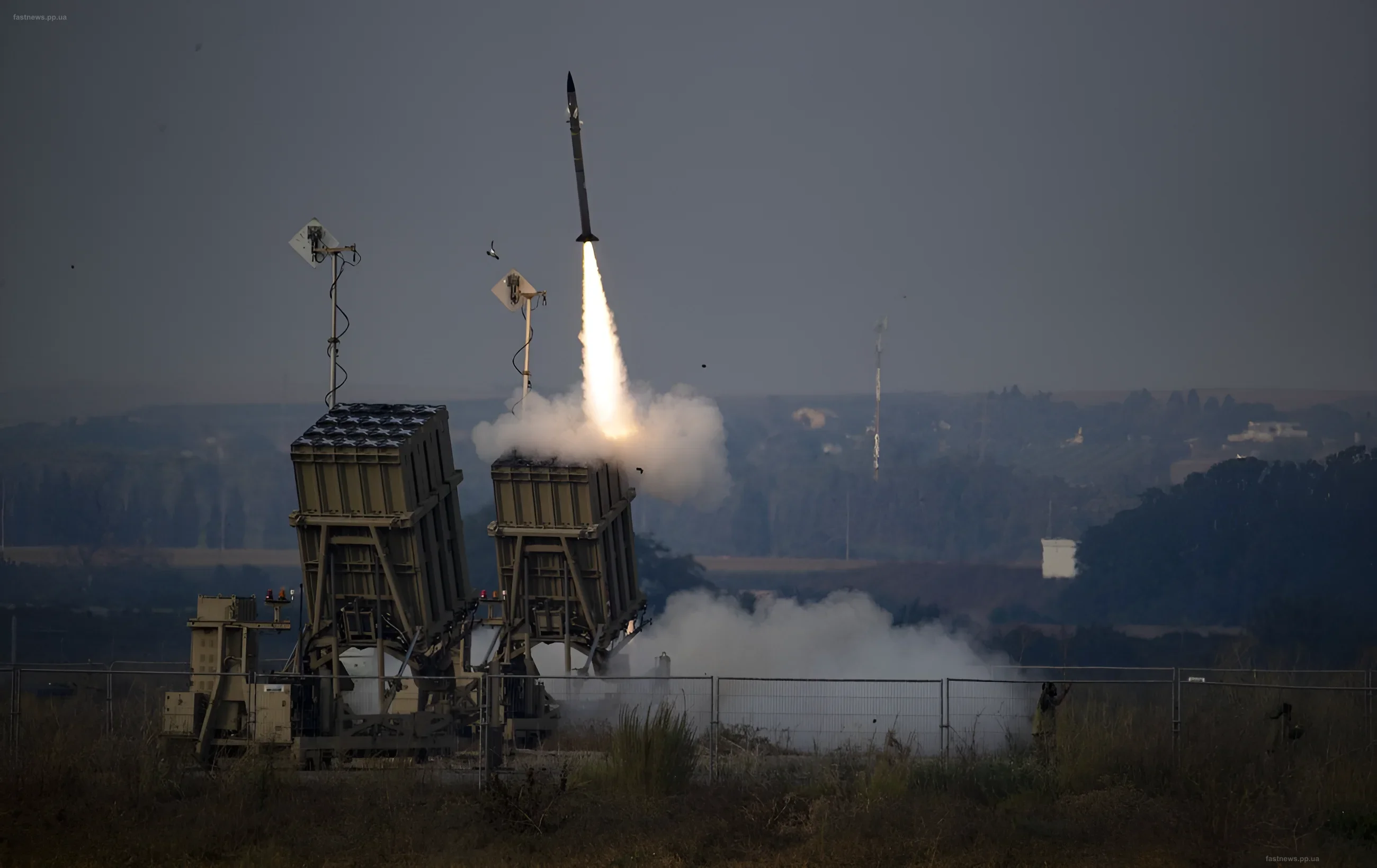 Missile launch from an air defense system against a smoky sky
