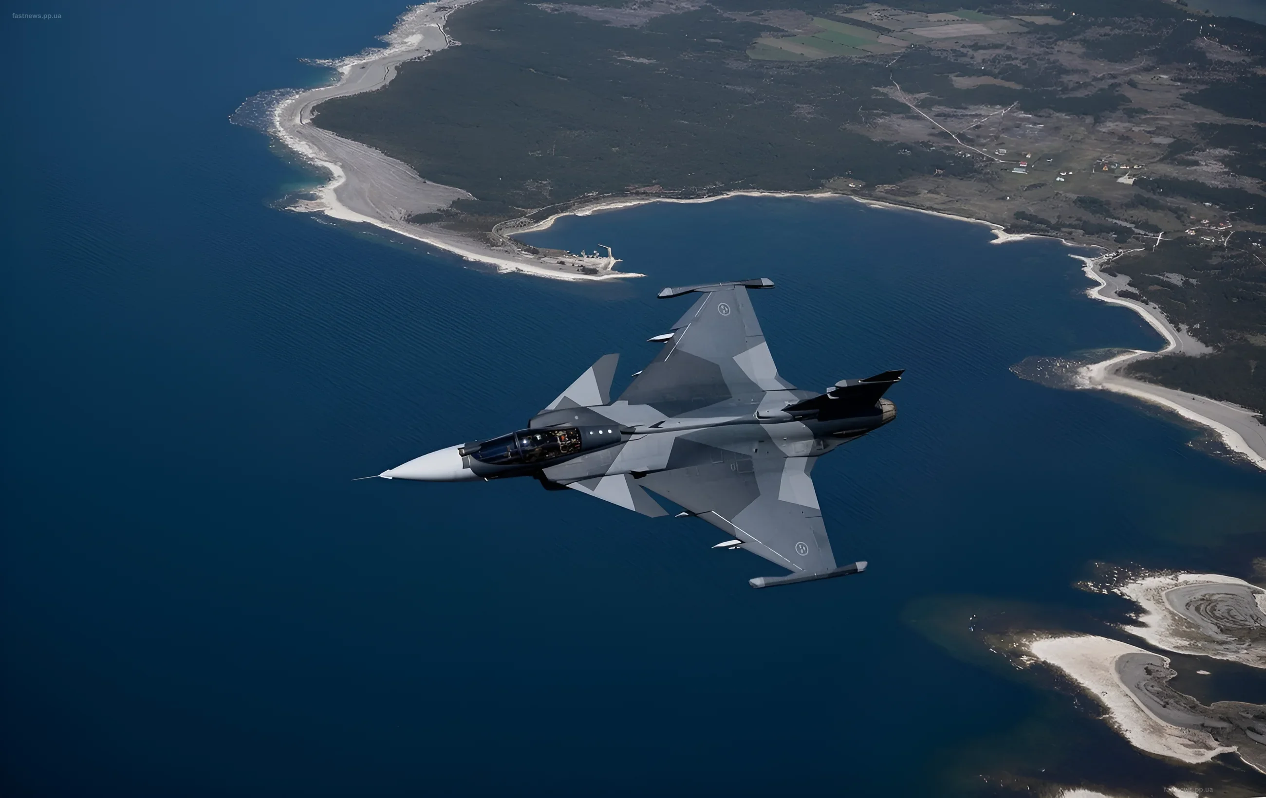 Шведский истребитель JAS 39 Gripen в полете над морским побережьем, демонстрируя свою маневренность и боевую готовность