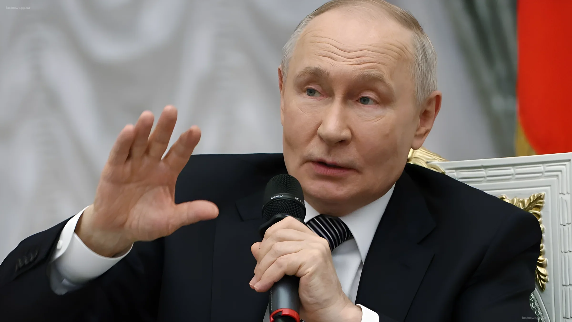 Vladimir Putin with a microphone during a speech, illustrating the theme of criticism of his economic policy