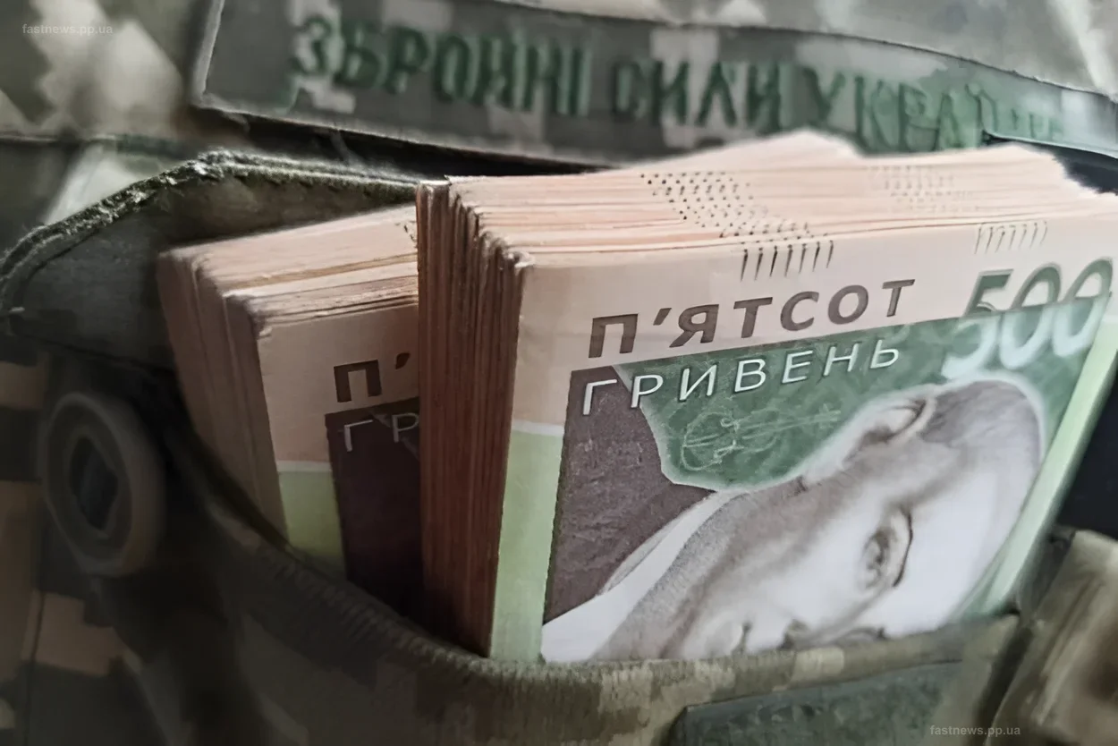 Stacks of Ukrainian hryvnias in a military uniform pocket, illustrating the topic of pension payments for military personnel