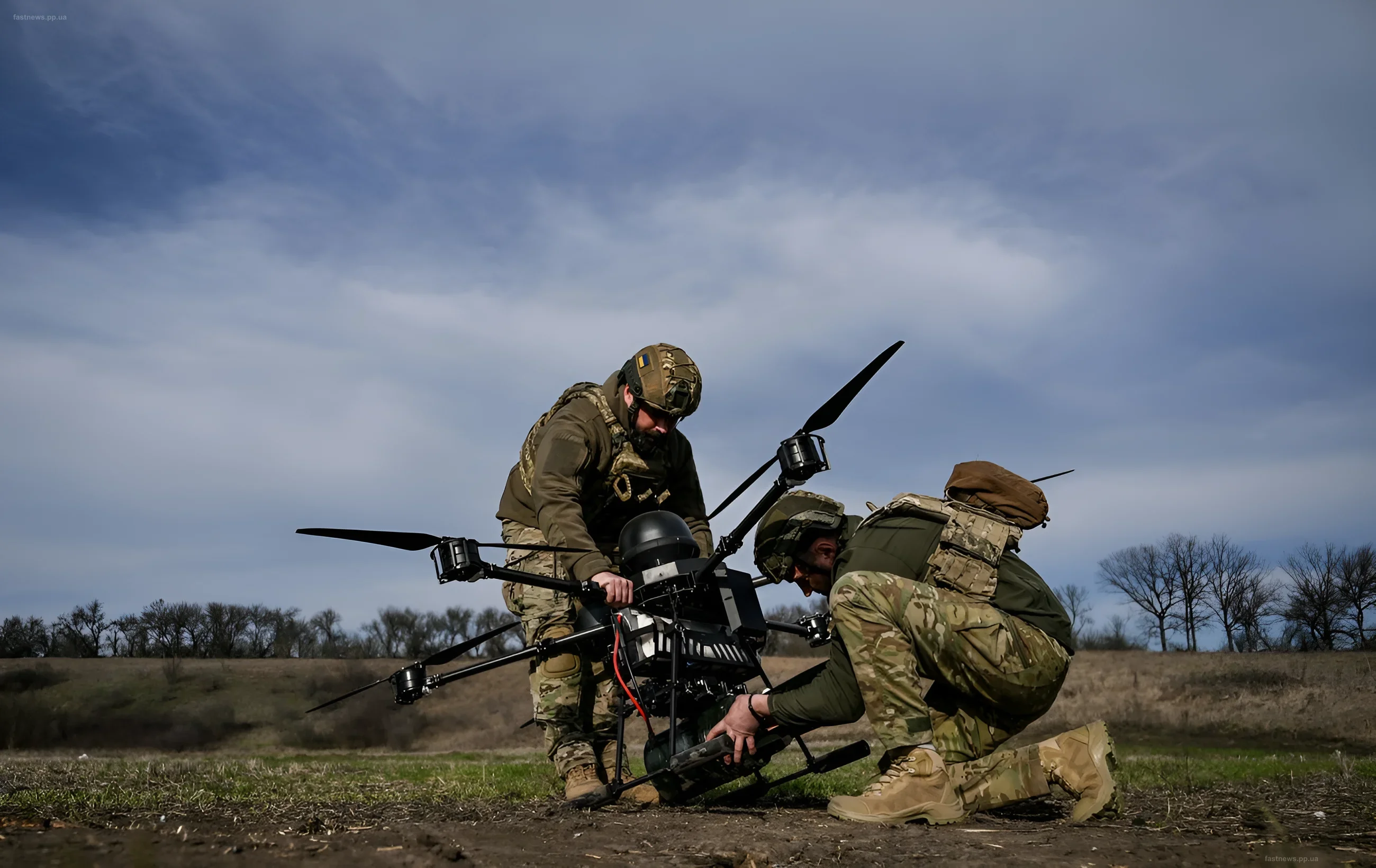 Ukrainian soldiers preparing a combat drone for launch in a field, readying for a strike on occupier targets