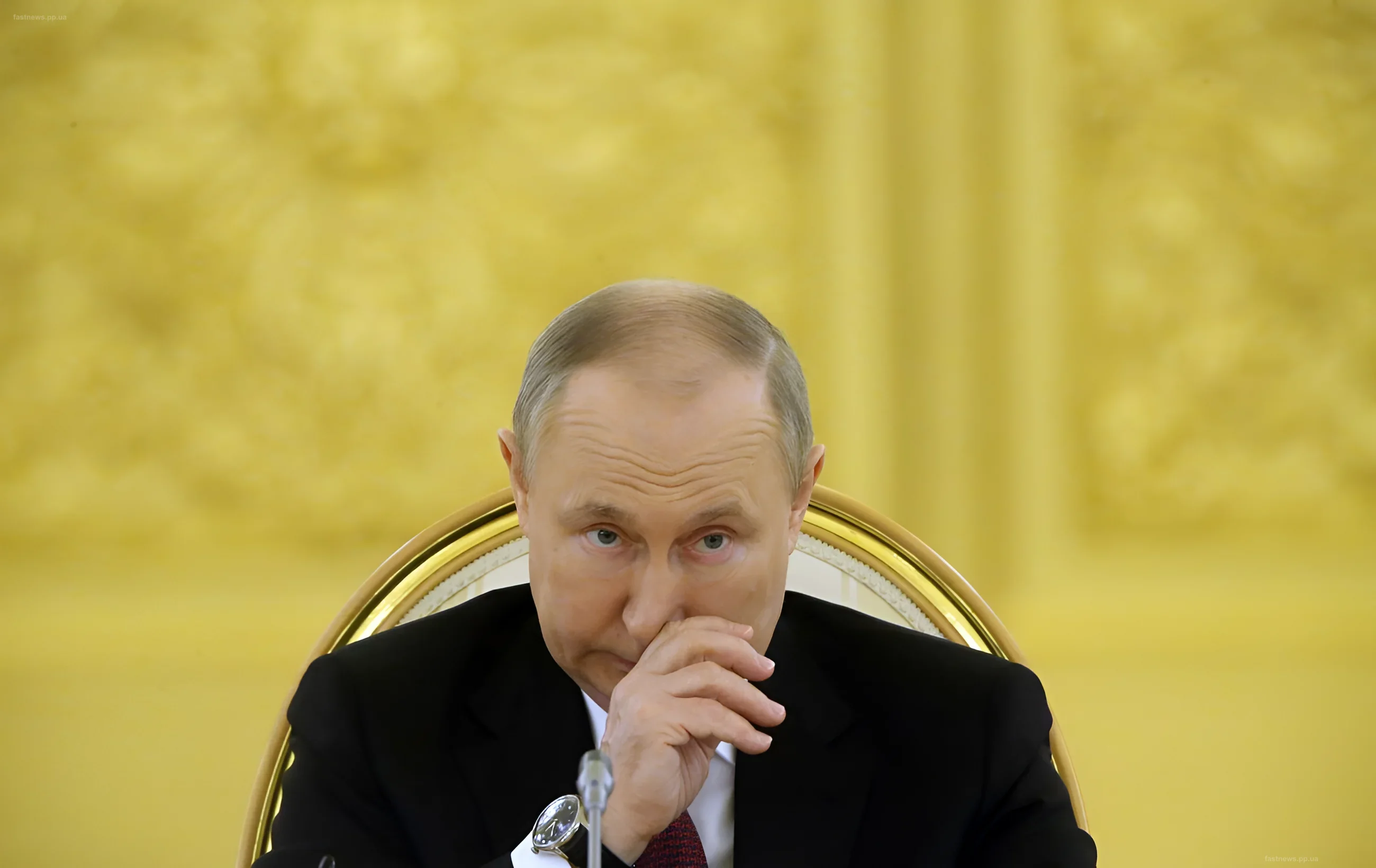 Vladimir Putin in a thoughtful pose against a backdrop of yellow curtains, symbolizing reflections on sanctions and technology theft