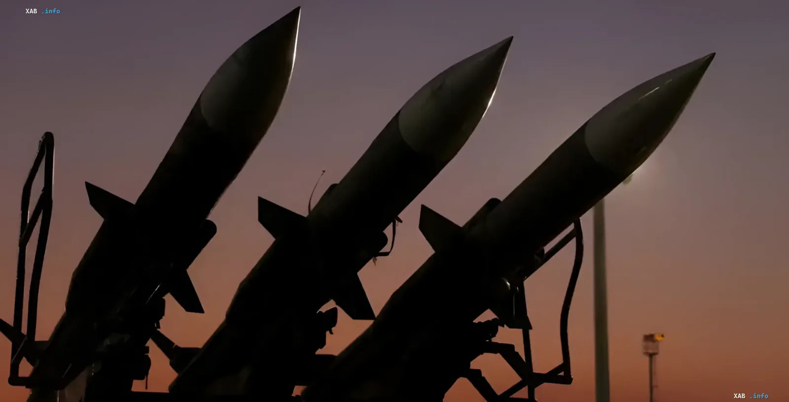 Silhouettes of missiles against a sunset in the Persian Gulf — symbol of escalating tension between the US and Iran