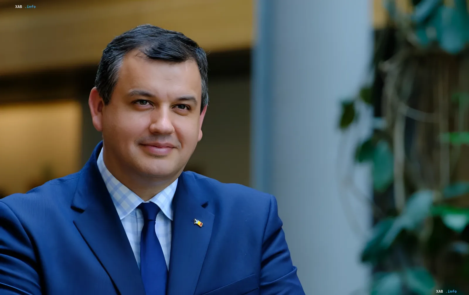 New Romanian Prime Minister in a blue suit with the national flag on his lapel, symbolizing technocrats taking power amid geopolitical tension