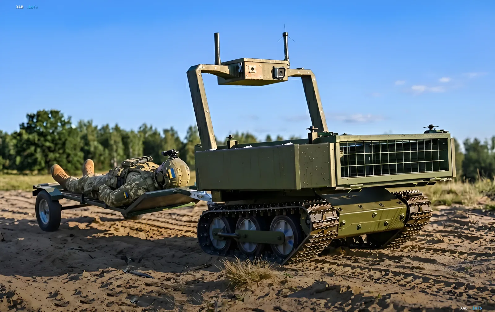 Combat robot Vepr evacuates a wounded soldier on a trailer in field battle conditions
