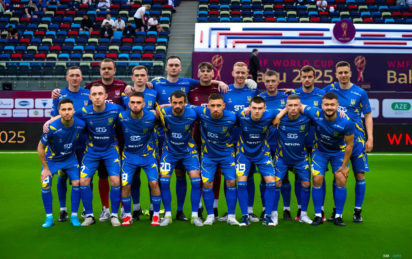 Ukraine national futsal team in blue kits with SDG logo and Ukrainian trident posing on stadium field before Euro 2026 final against Azerbaijan