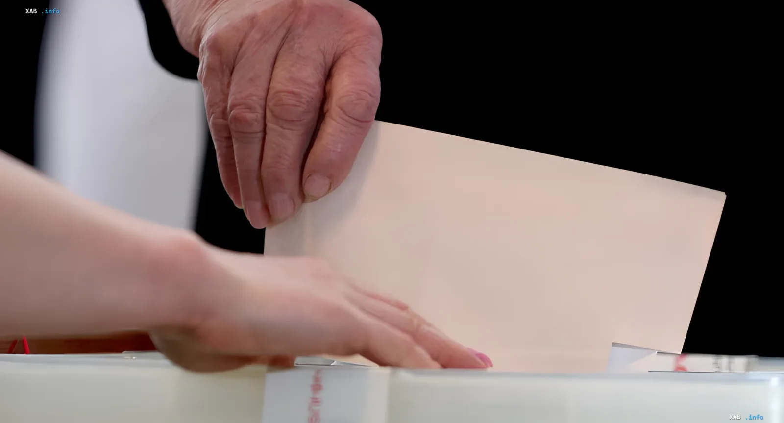 Voting in Armenia: a voter casts a ballot into the box amid high turnout