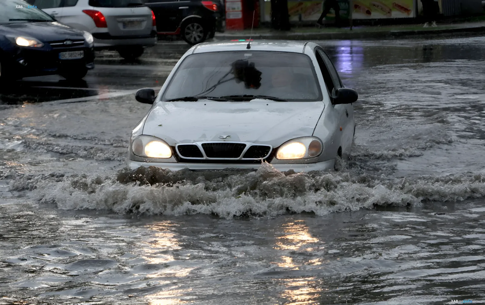 Car driving through a heavily flooded street in Kyiv during rain and thunderstorm