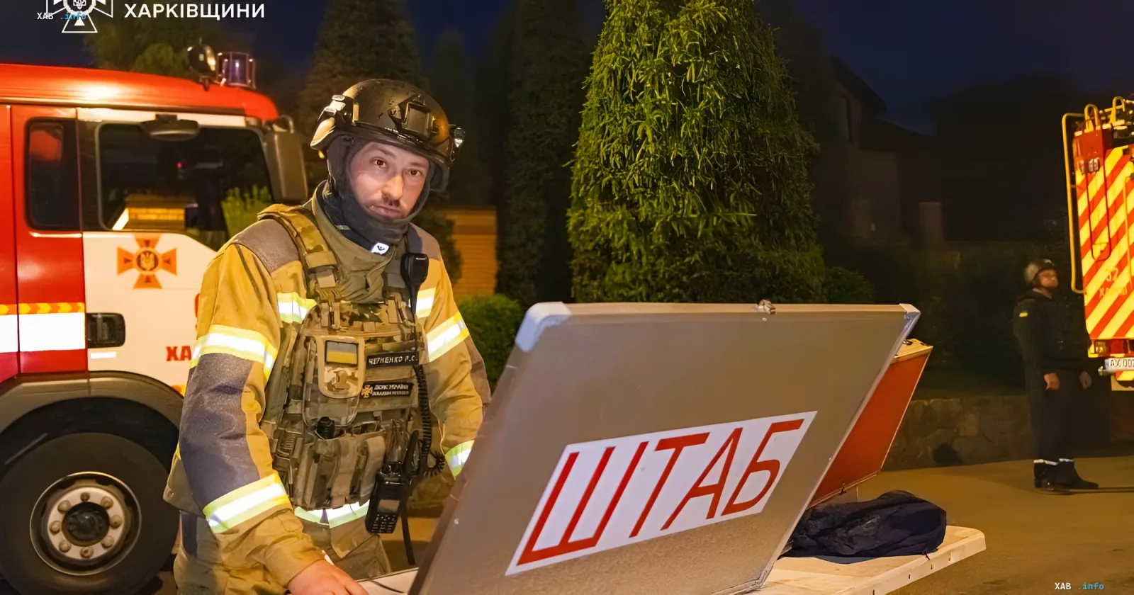 Rescuer at the site of a massive strike on Kharkiv region, working at a command table at night