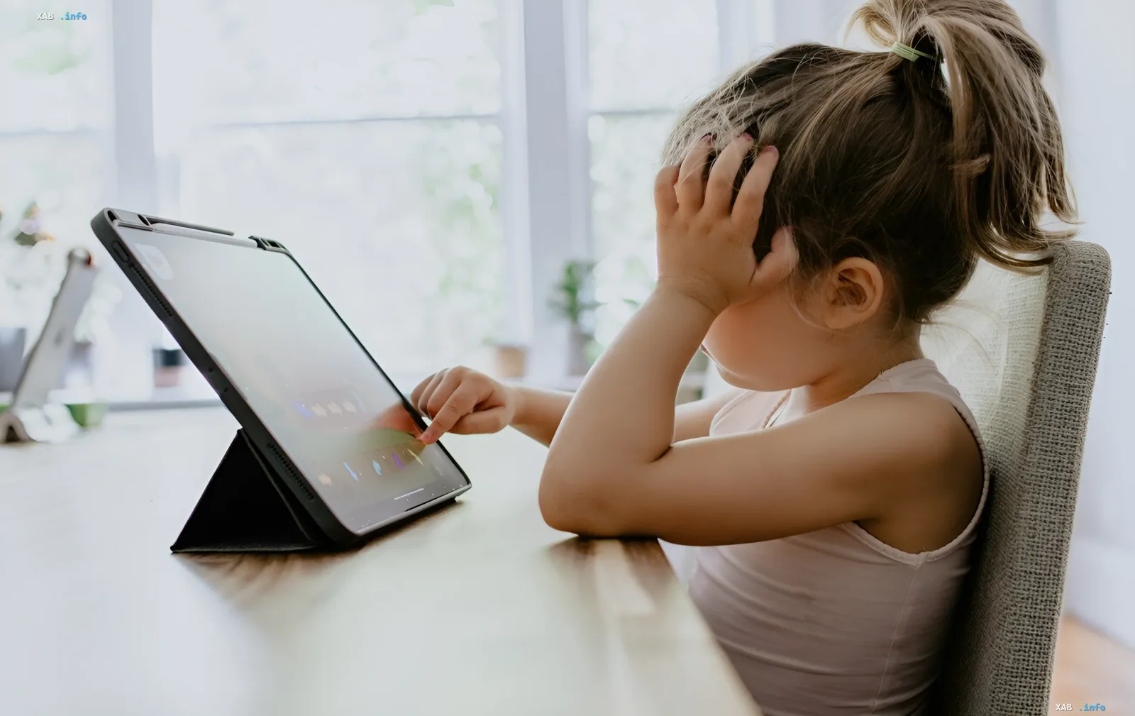 Girl looking confused at tablet displaying Minecraft — symbol of digital trap where kids accidentally buy webcam access for $5/month