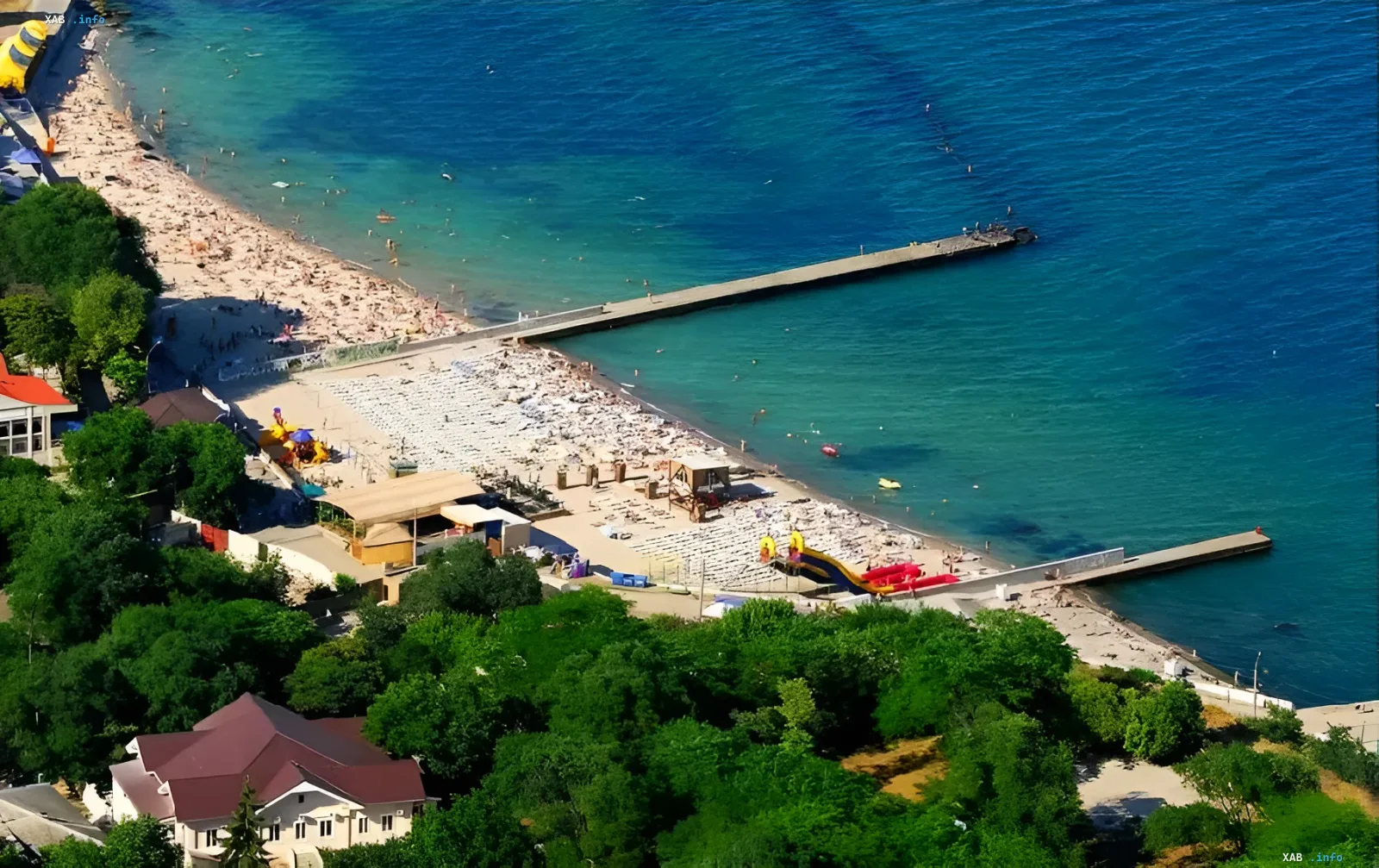 Beach in Odesa with tourists and rescue towers, showcasing safe vacation conditions during wartime
