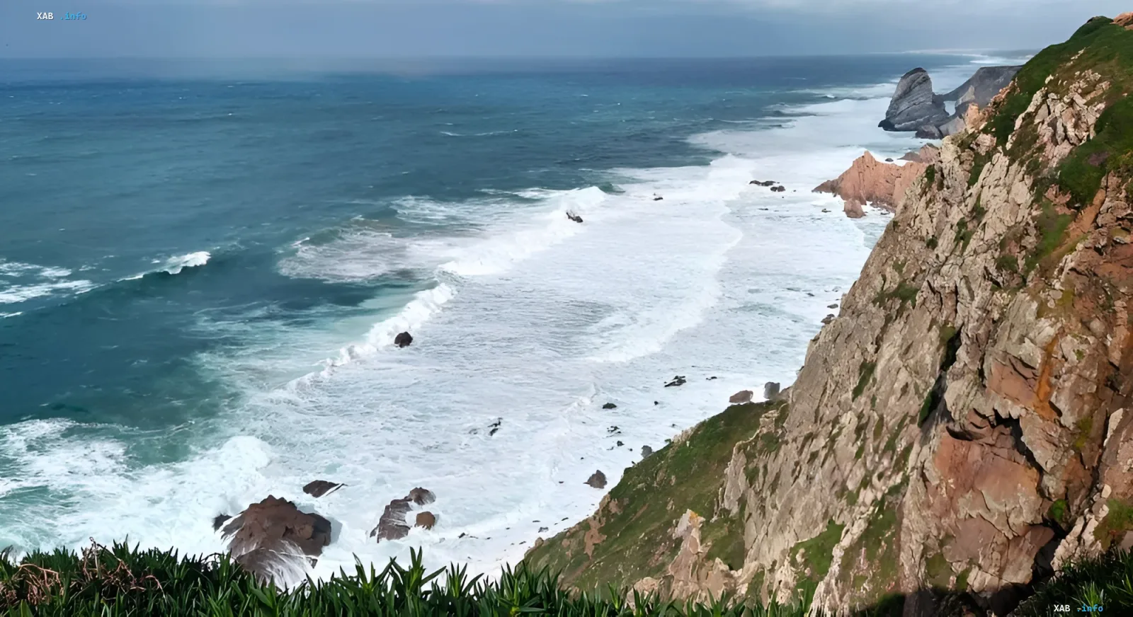 Powerful waves crash against the rocky shores of the Algarve in Portugal, illustrating the need for investment to protect beaches from erosion