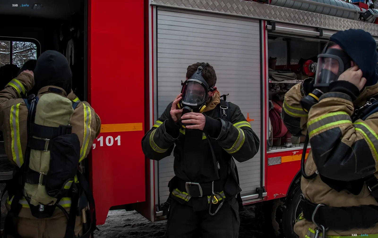 Firefighters in protective gear prepare to extinguish a fire at the Tolyatti Kautchuk plant after a drone attack in Tolyatti