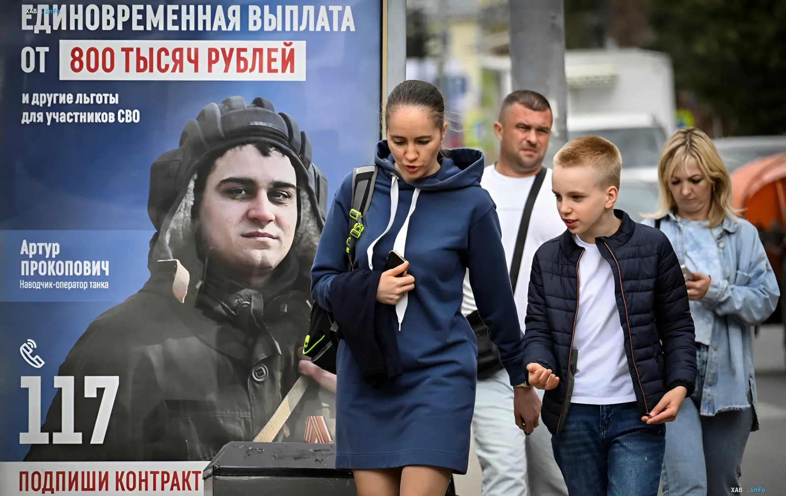 Рекламный щит вербовки в СВО с обещанием выплаты 800 тысяч рублей на фоне прохожих в России