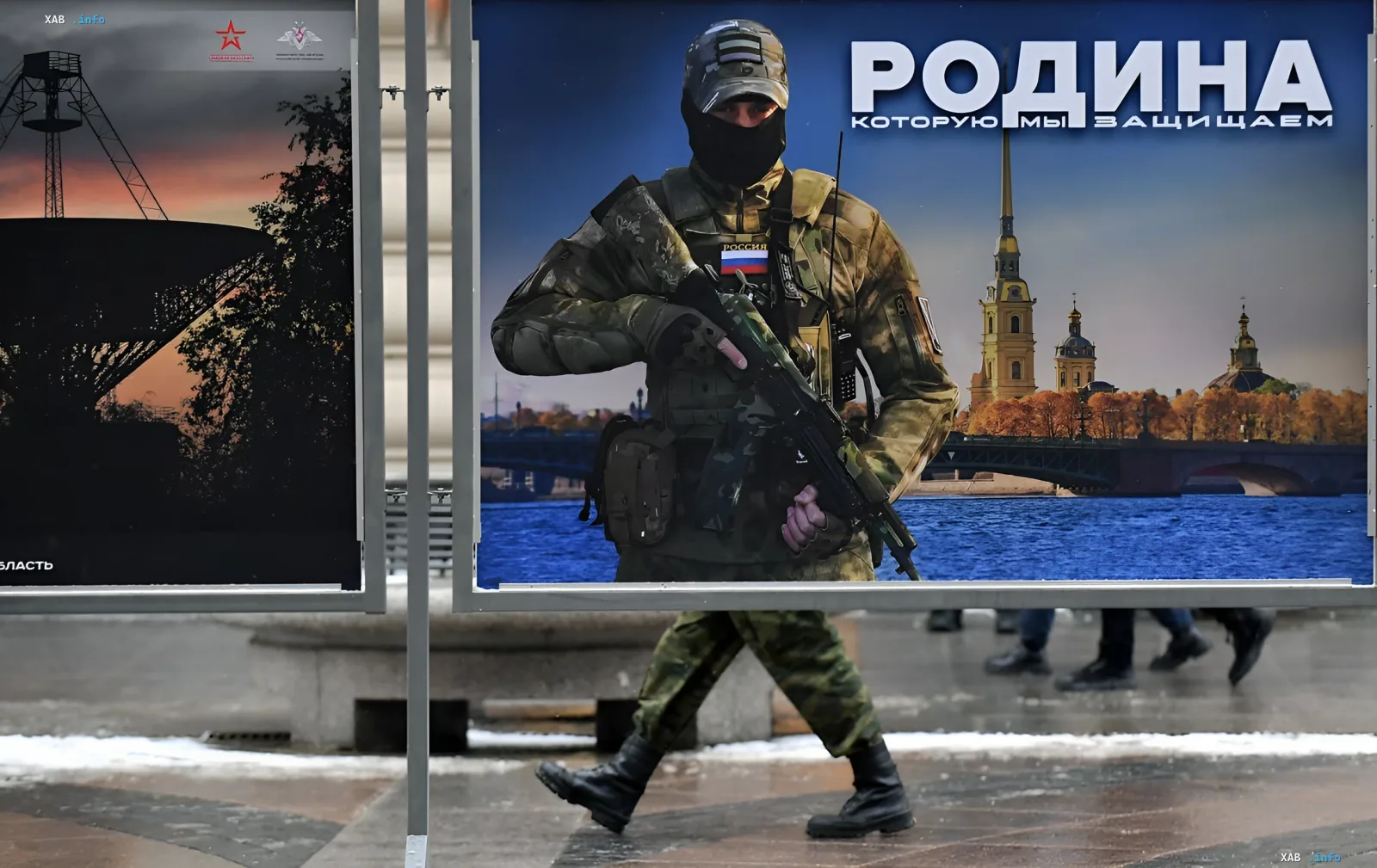Российский военнослужащий на фоне пропагандистского плаката с надписью «Родина, которую мы защищаем», иллюстрирующий рост военных расходов в 2026 году