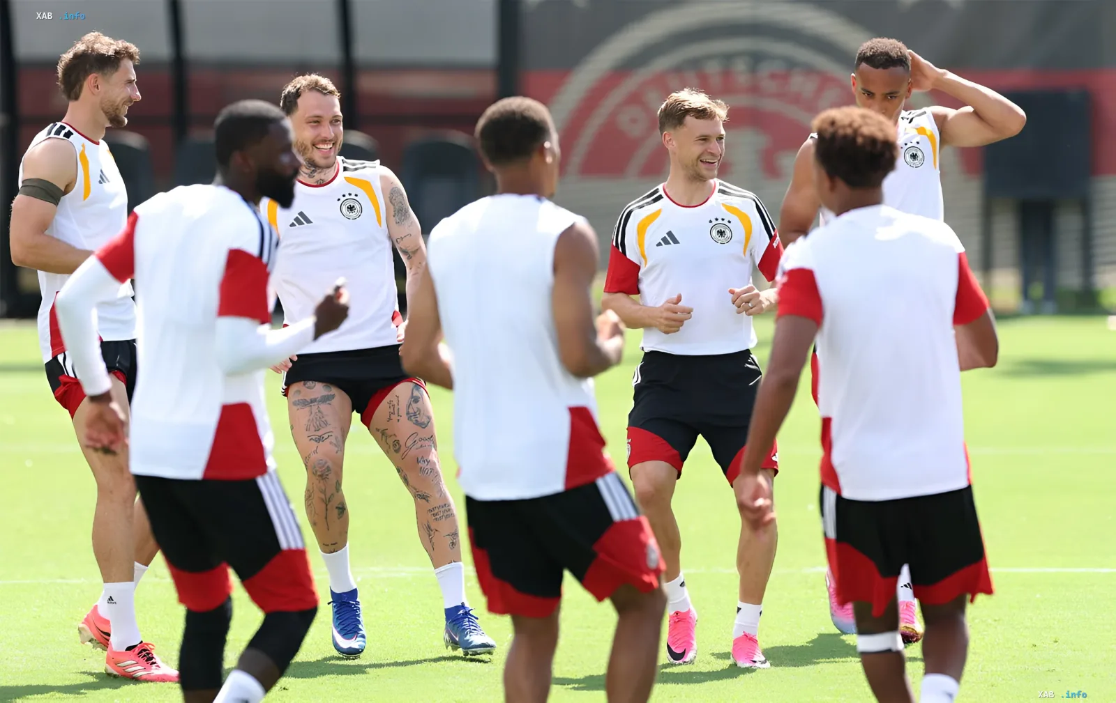 Germany national team training before match against Ivory Coast at WC-2026: players in team kit smiling and chatting on the field