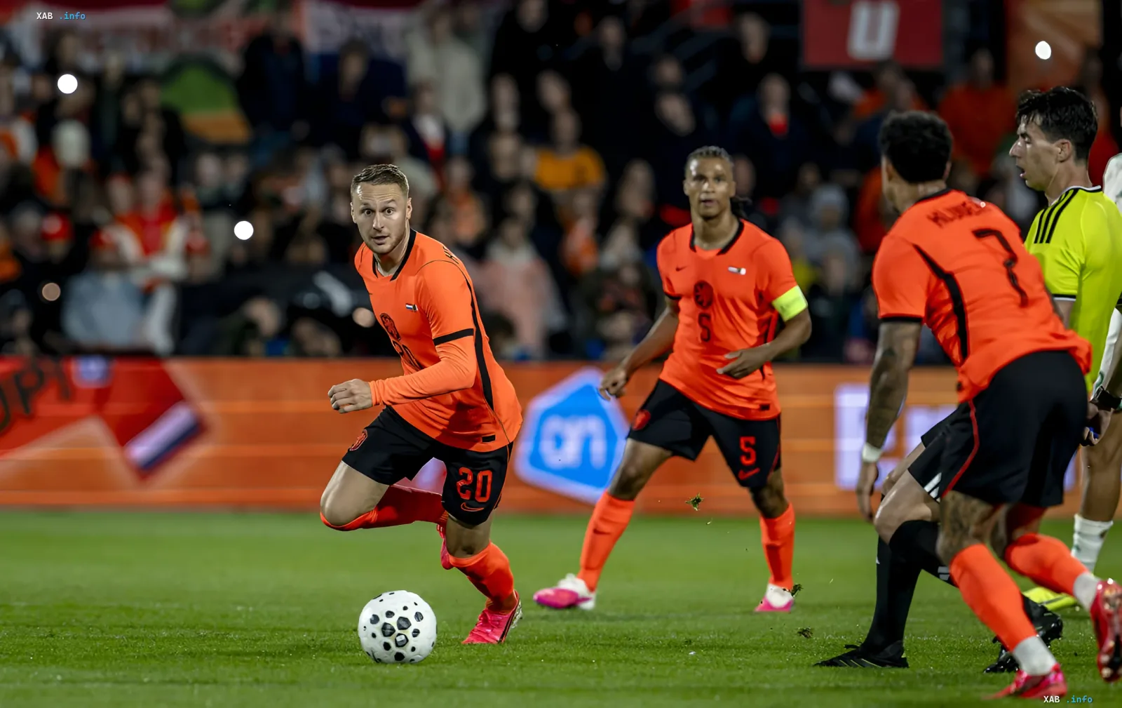Netherlands player in orange kit controlling the ball during a World Cup 2022 match