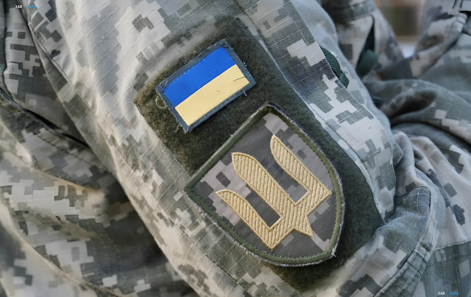 Ukrainian soldier in camouflage with flag and trident — symbol of digital war and cyber defense