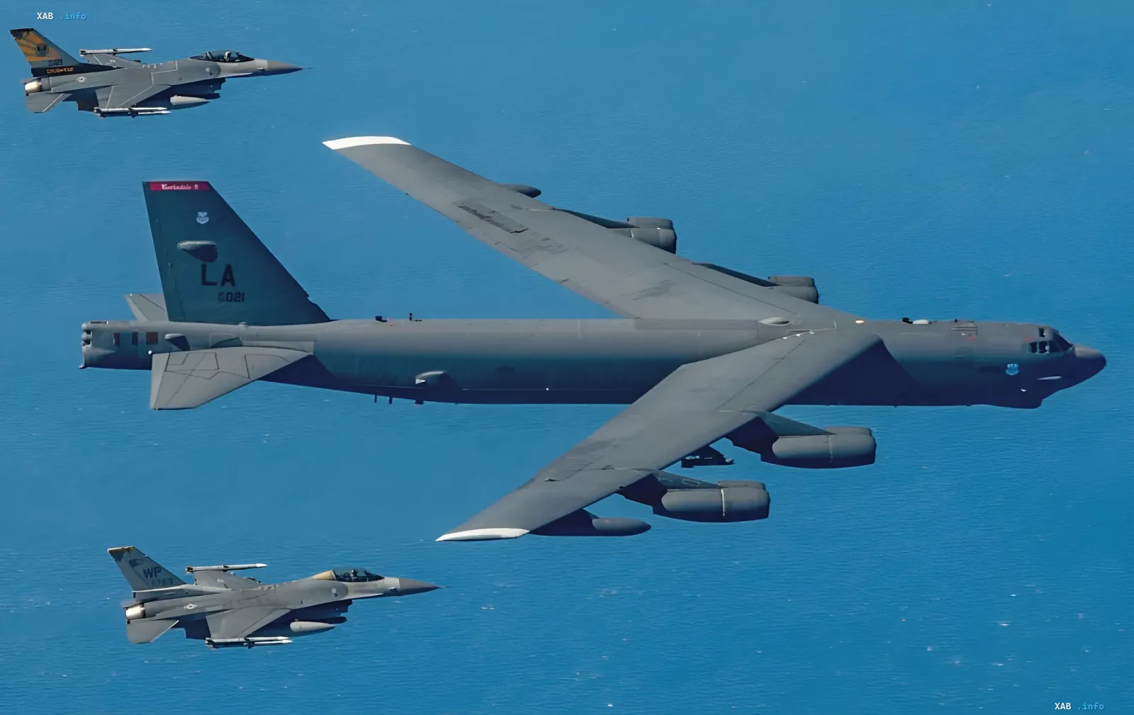 Стратегический бомбардировщик B-52 Stratofortress в полете с эскортом истребителей F-16 над океаном