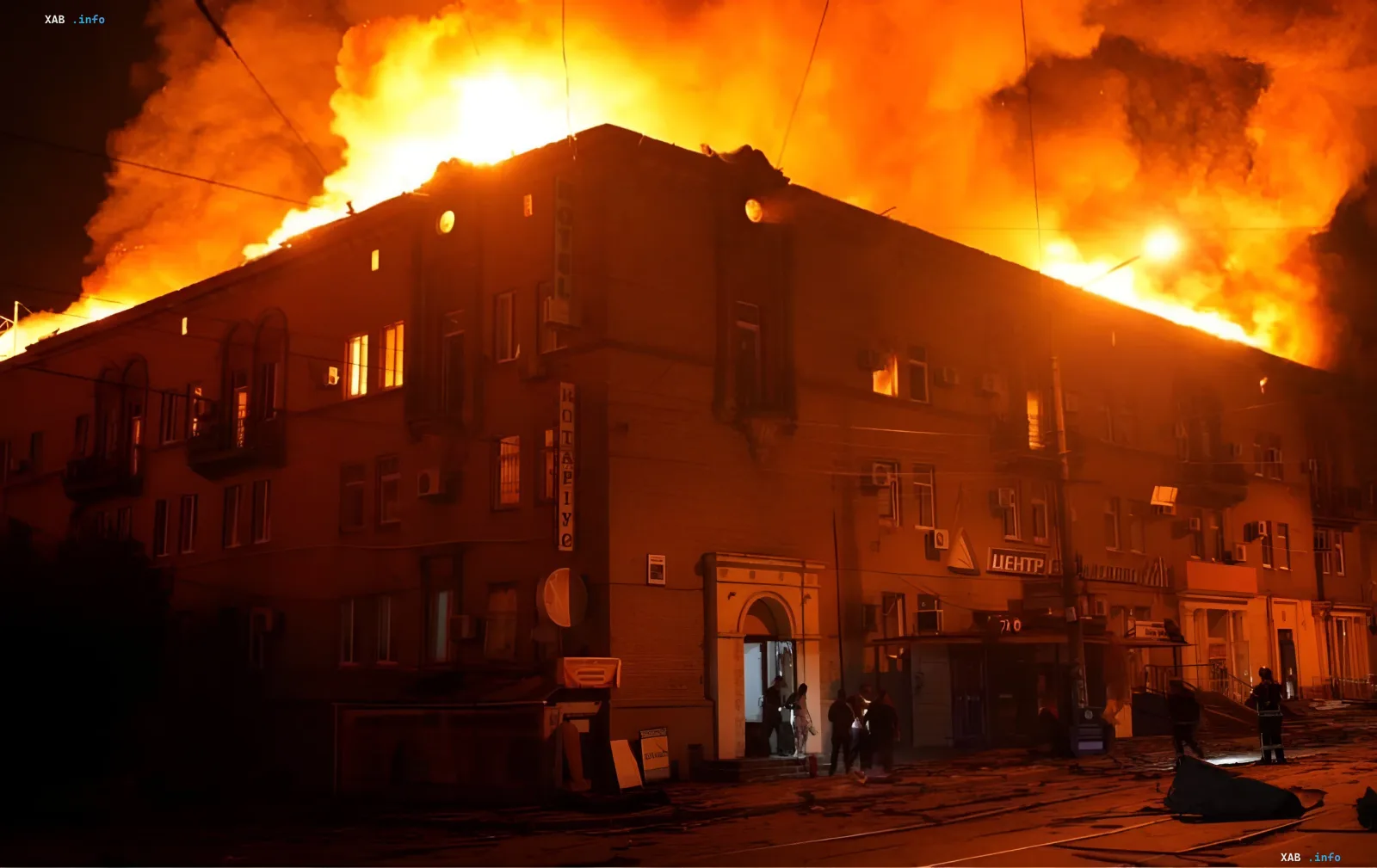 Massive fire engulfs building in Zaporizhzhia after Russian strike on June 16 — flames visible on roof, smoke, and people near entrance