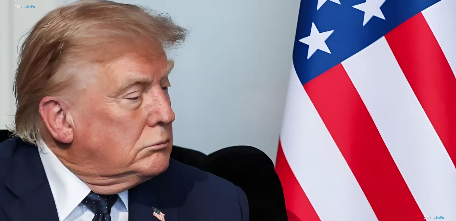 Donald Trump in deep thought beside the American flag, preparing to personally read the text of the agreement with Iran