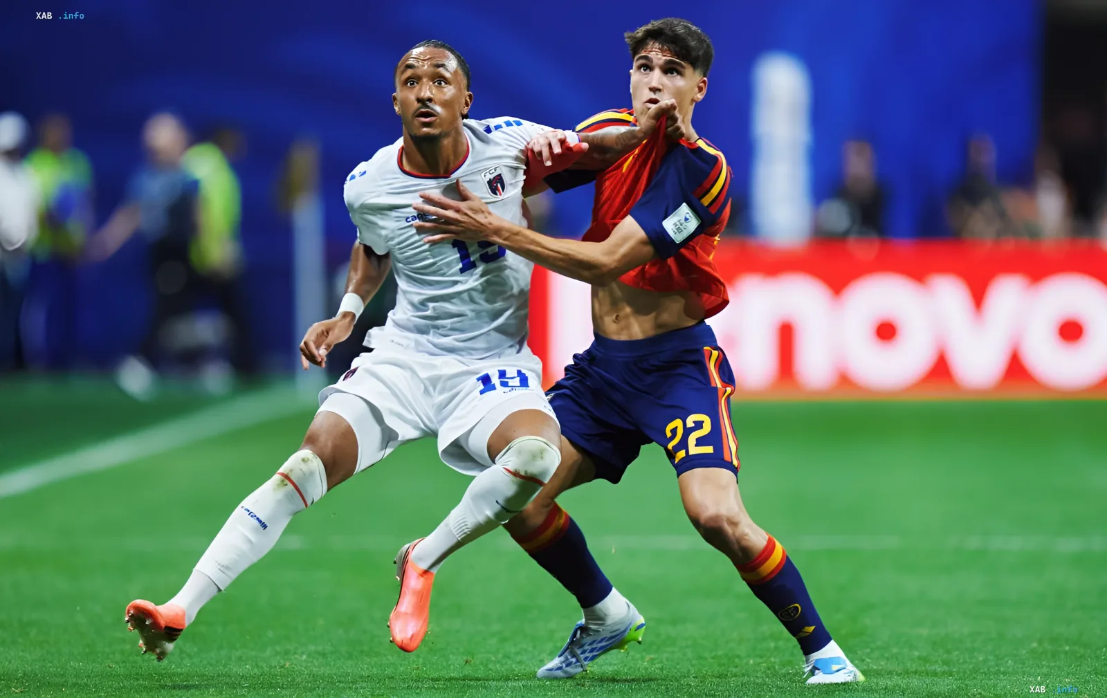 A player from the French national team in a white kit and a player from the Spanish national team in a red-and-blue kit compete for the ball during a World Cup 2026 qualifying match