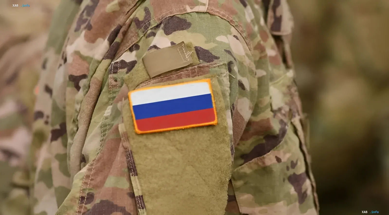 Russian military flag on camouflage uniform, illustrating the topic of visa restrictions for Russian military personnel