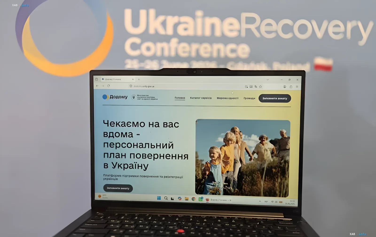 Laptop displaying the 'Dodomu' platform website in front of a UkraineRecovery Conference banner