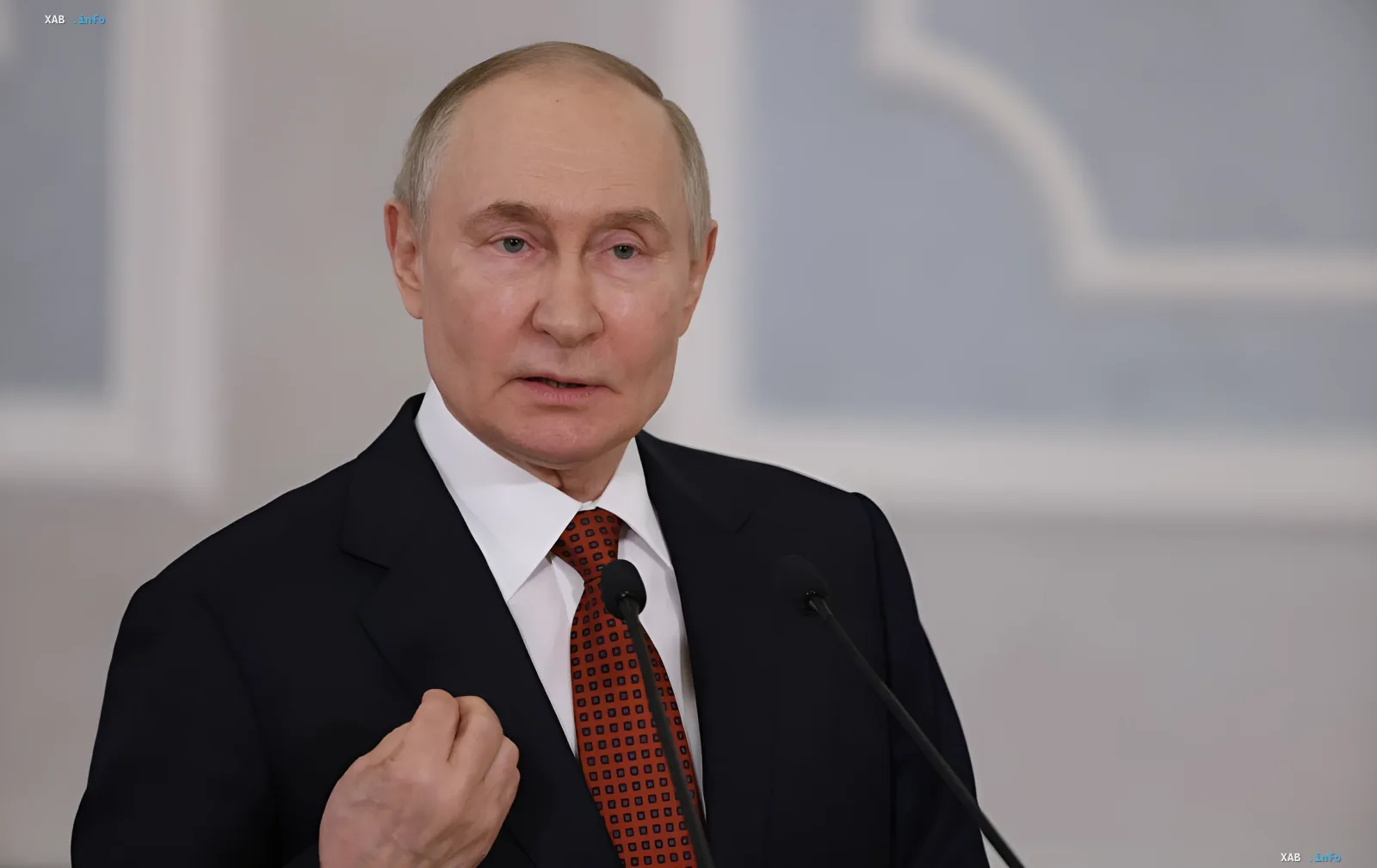 Vladimir Putin delivers a speech against a neutral interior backdrop, symbolizing the geopolitical context of Europe’s shift from peace initiatives to a military alliance