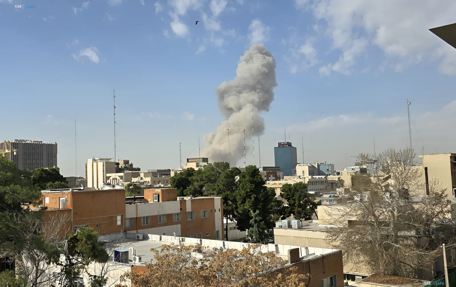 Thick smoke rises over a city following a missile strike, illustrating Iran's retaliatory attack on US bases in Kuwait and Bahrain