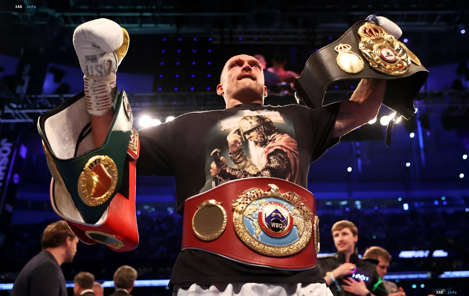 Oleksandr Usyk with four world championship belts in the heavyweight division, symbolizing the end of his era and upcoming changes in boxing