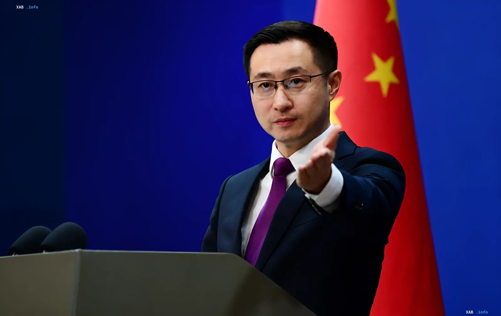 Chinese official spokesperson delivers statement calling for immediate negotiations between Moscow and Kyiv against backdrop of PRC flag